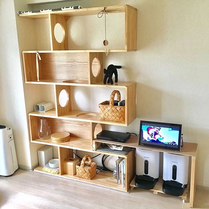 a living room filled with furniture and a flat screen tv sitting on top of a wooden shelf