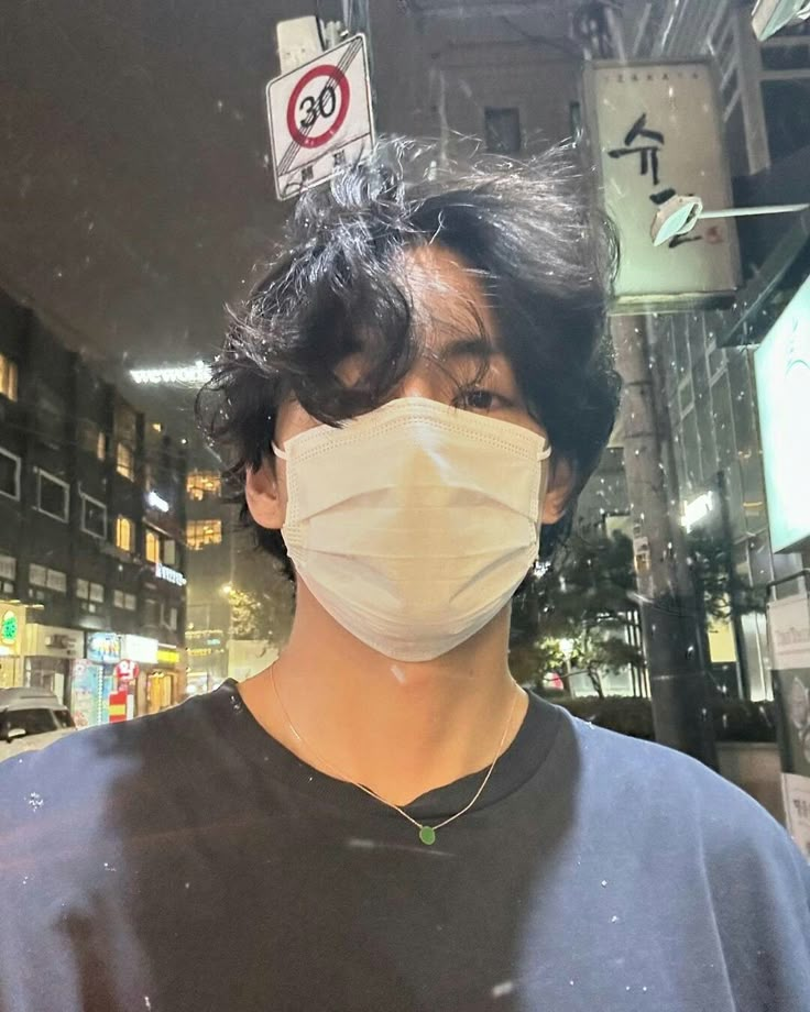 a man wearing a face mask in the city