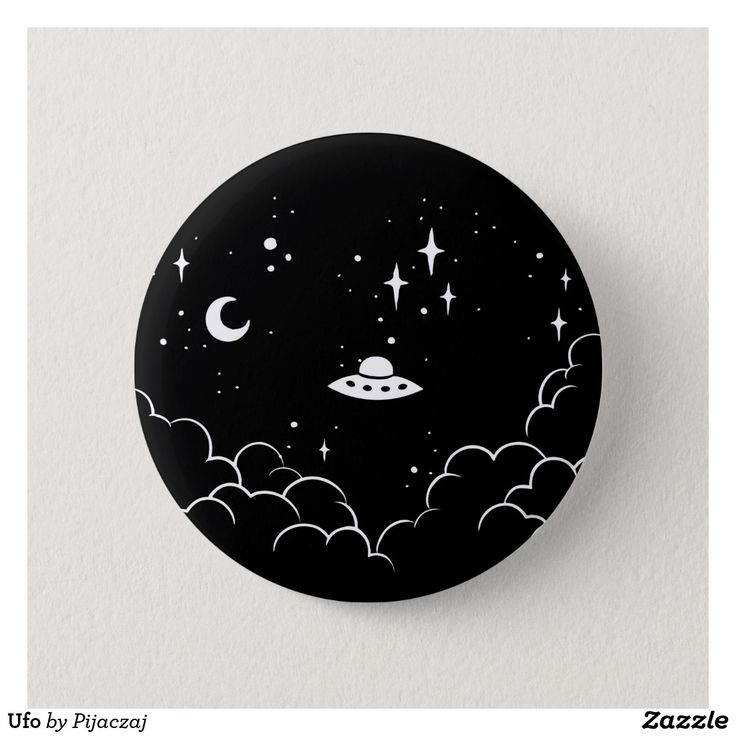 a black and white button with an image of a space ship flying through the night sky