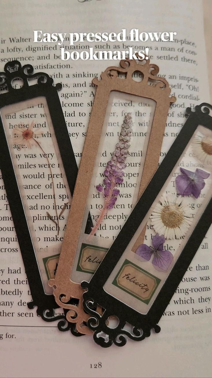 three bookmarks with flowers in them sitting on top of an open book page that reads easy pressed flower bookmarks