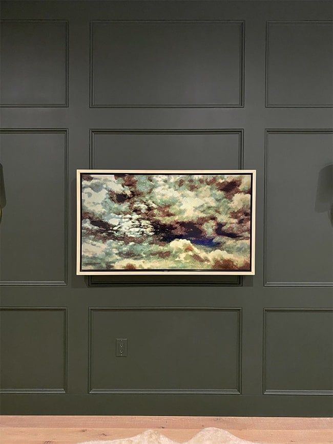 a painting hanging on the wall in an empty room