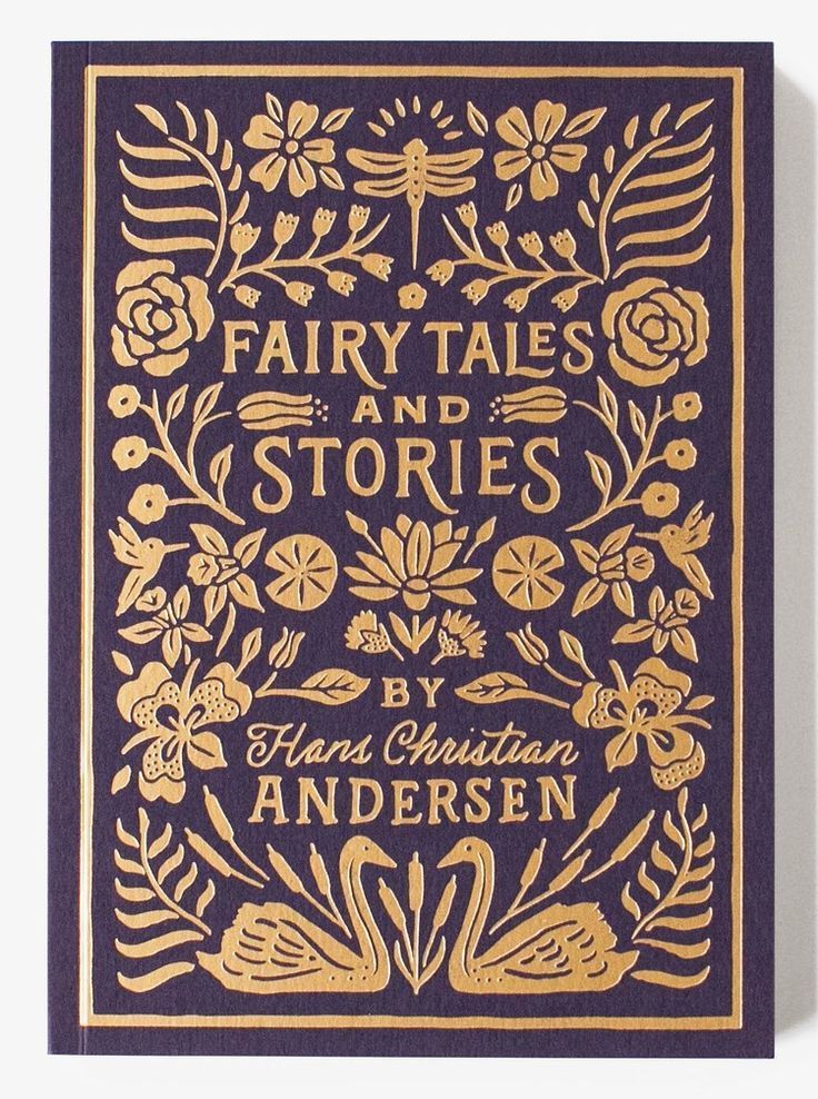 a blue and gold book cover with floral designs on the front, in gold foil