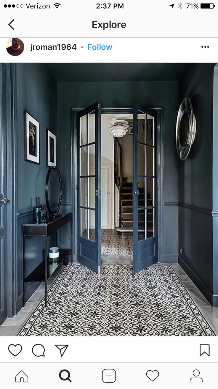 a hallway with blue walls and black doors