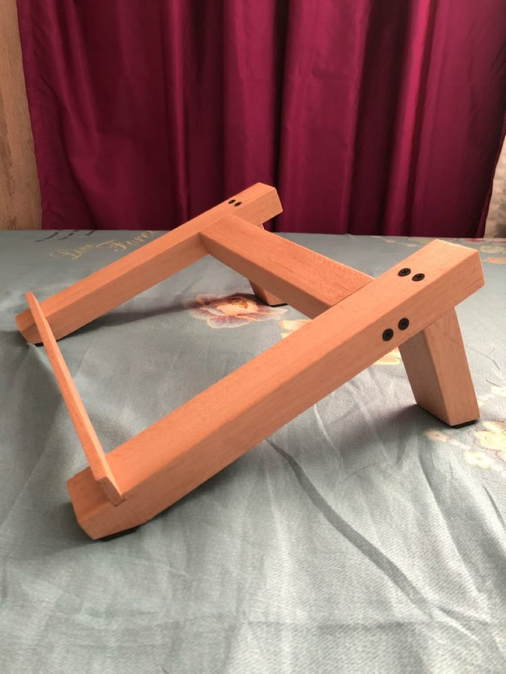 a wooden frame sitting on top of a bed