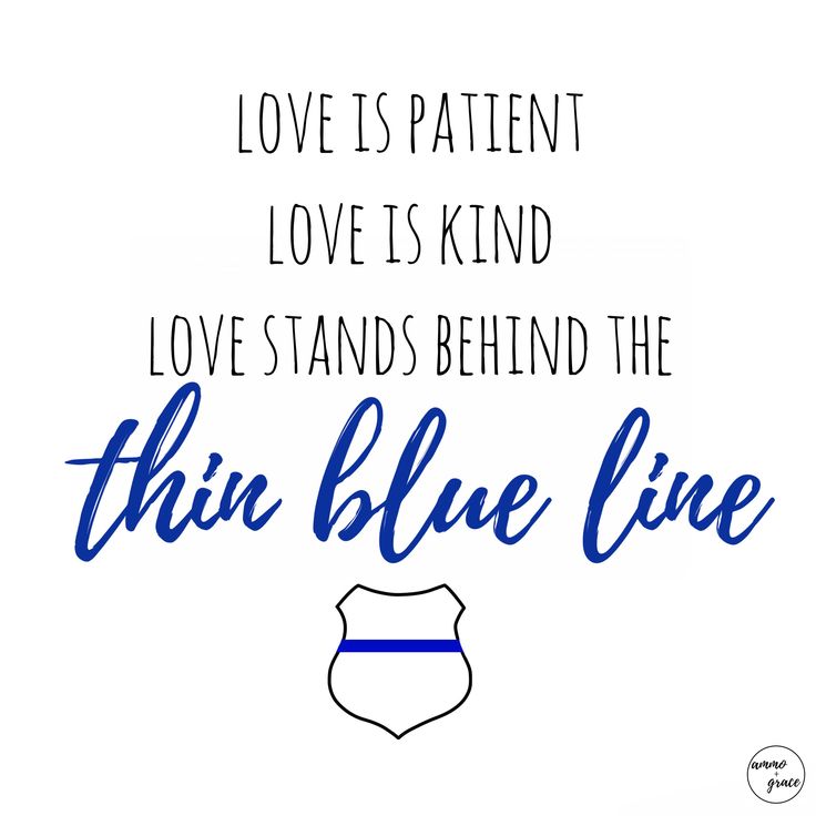 a blue line sign that says love is patient love is kind love stands behind the thin blue line