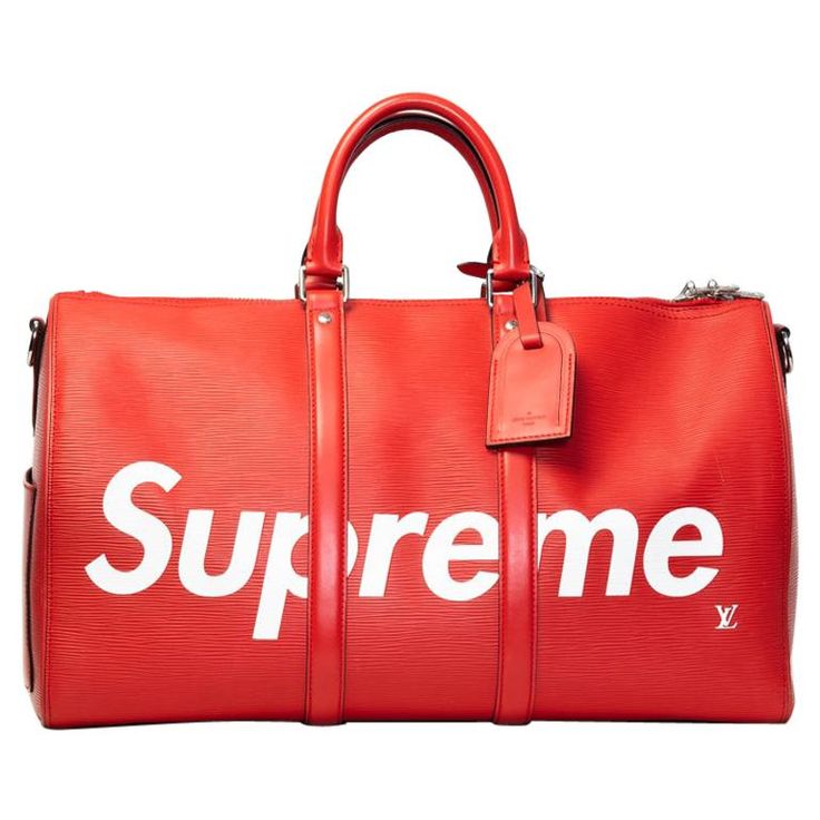 This iconic Keepall bag by Louis Vuitton and Supreme is made of red epi leather and features white Supreme logo, a detachable red leather shoulder strap, silver tone hardware, a two-way zipper closure, an exterior slip pocket & an interior zipper pocket, & black fabric interior lining. COLOR: Red MATERIAL: Epi Leather DATE CODE: BA2137 MEASUREMENTS: H 11” x L 18” x D 8” COMES WITH: Attachable Strap 40”, detachable luggage tag, LV lock & key, dust bag CONDITION: Pristine. Some hairline scratches on the bottom from being handled. Very clean. Some marks on the bottom. Made in France Luxury Red Bottoms With Pockets, Luxury Red Tote Travel Bag, Luxury Red Travel Bags, Luxury Red Duffle Bag For Travel, Luxury Red Bags For Travel, Luxury Red Bags With Logo, Luxury Red Duffle Bag For Daily Use, Luxury Red Shopping Bags, Luxury Red Weekender Bag For Everyday Use