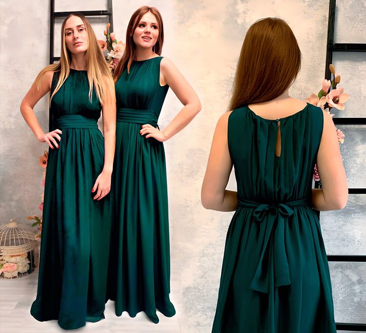 a woman in a green dress is looking at herself in the mirror with her hands on her hips