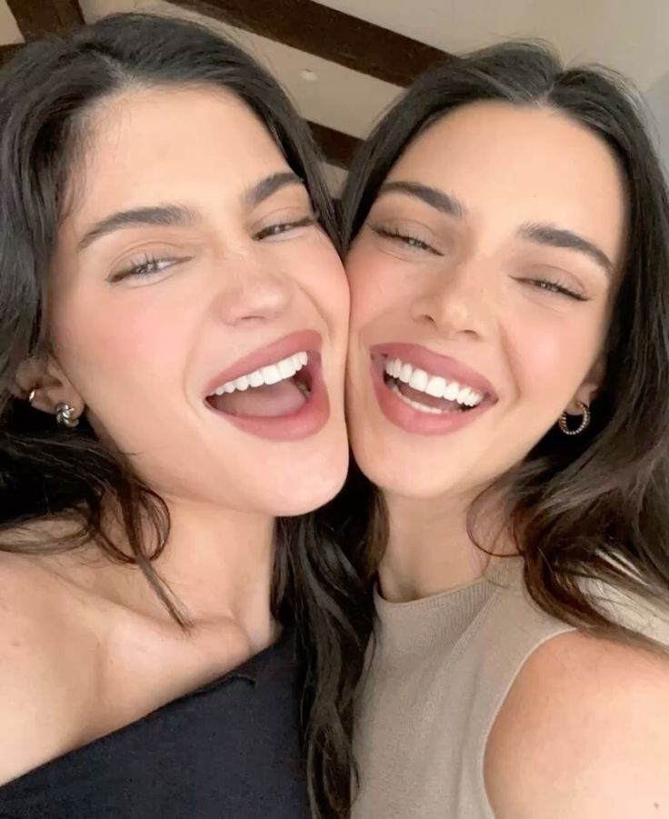 two women are posing for the camera with their mouths open and one has her eyes closed