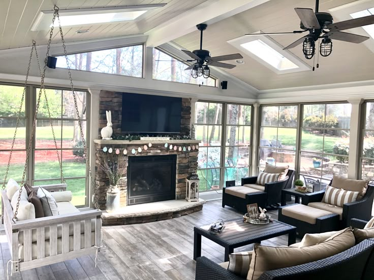 a living room filled with furniture and a flat screen tv mounted to the wall next to a fire place