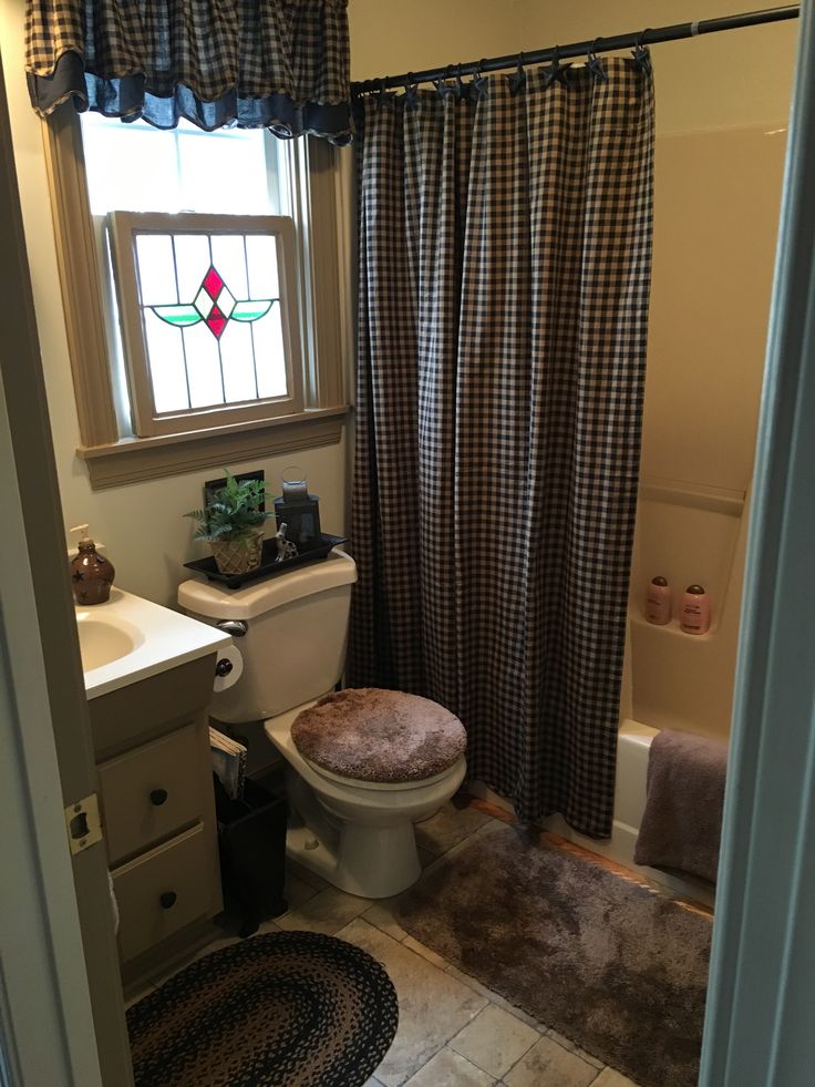 a bathroom with a toilet, sink and bathtub