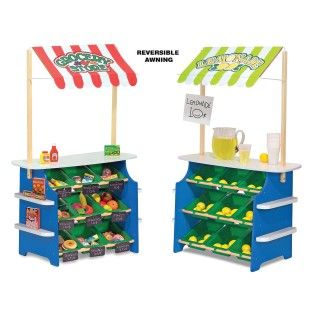 two children's toy food stands with signs on them and an advertisement for the store