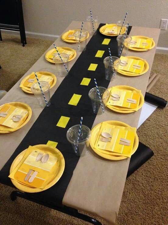 a table set up with yellow plates and napkins