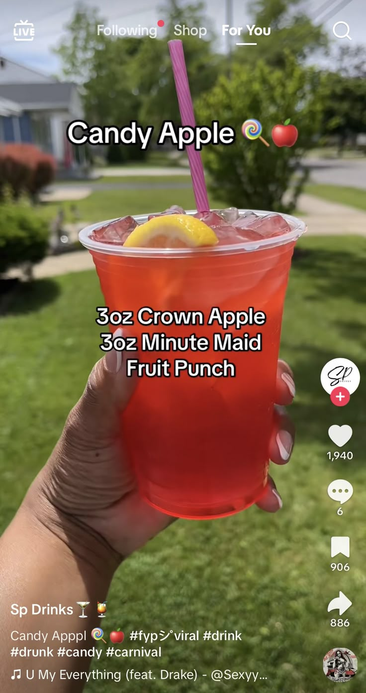 a person holding up a drink in their hand with the caption, candy apple 32 - minute maid fruit punch