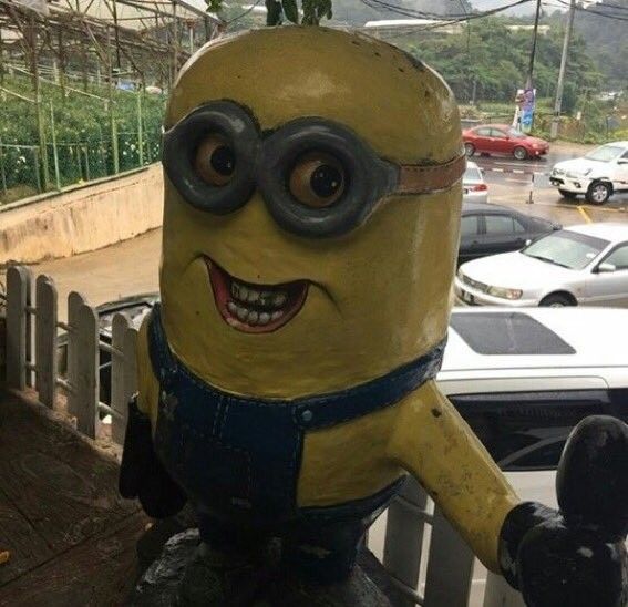 a statue of a minion with big eyes