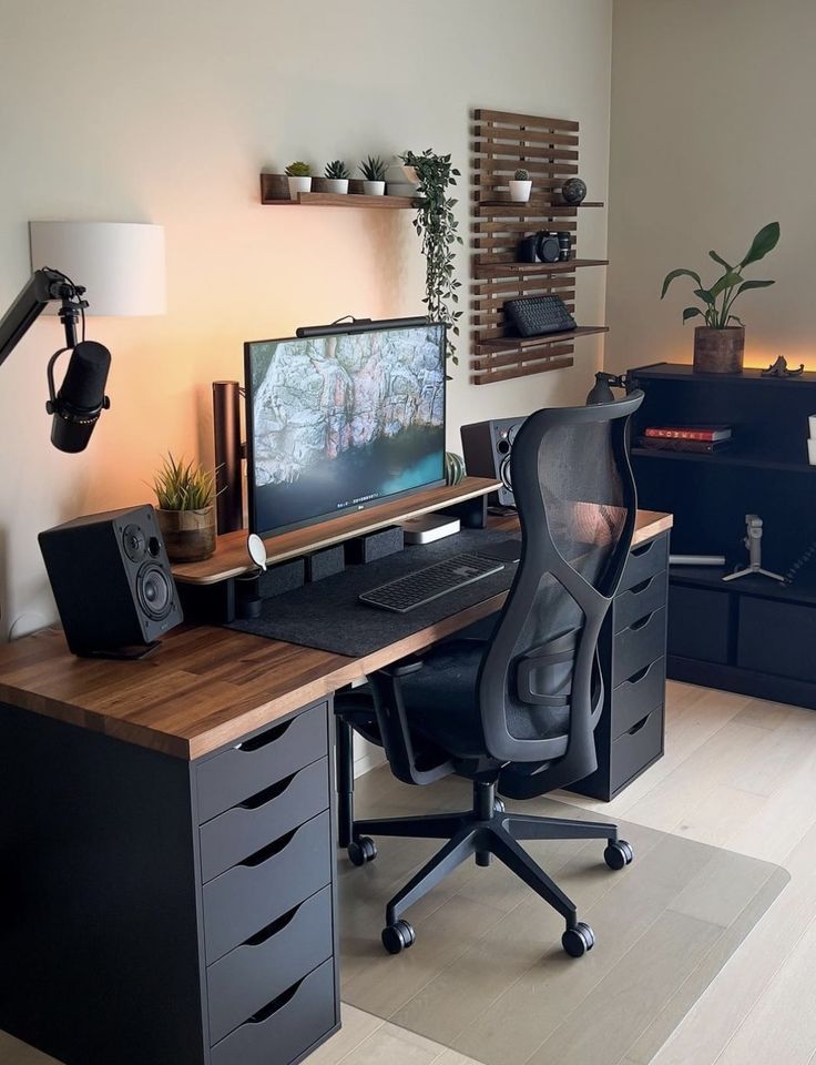 a computer desk with a monitor, keyboard and speakers sitting on it's side