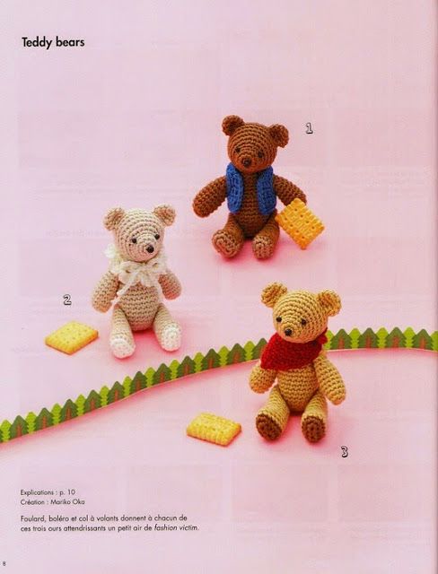 three crocheted teddy bears sitting next to each other on a pink surface with green grass