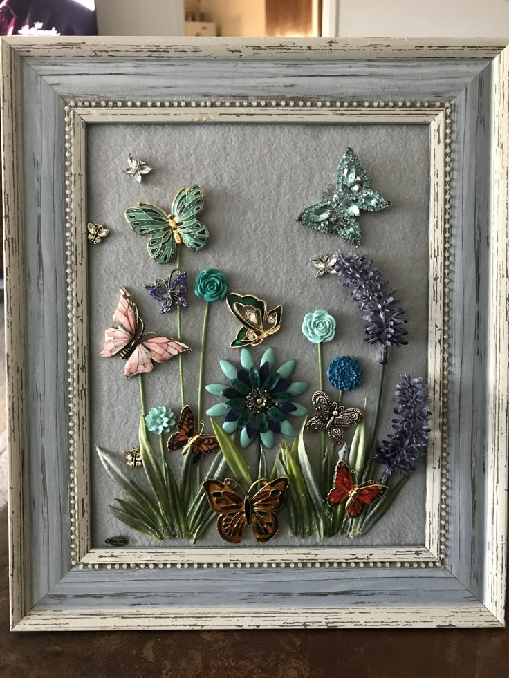 a frame with flowers and butterflies in it