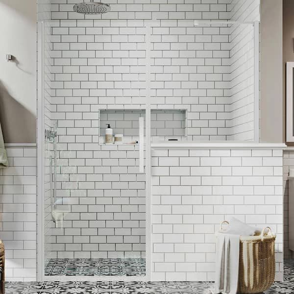 a bathroom with white tile and black and white floor tiles on the walls, shower stall door, and towel rack