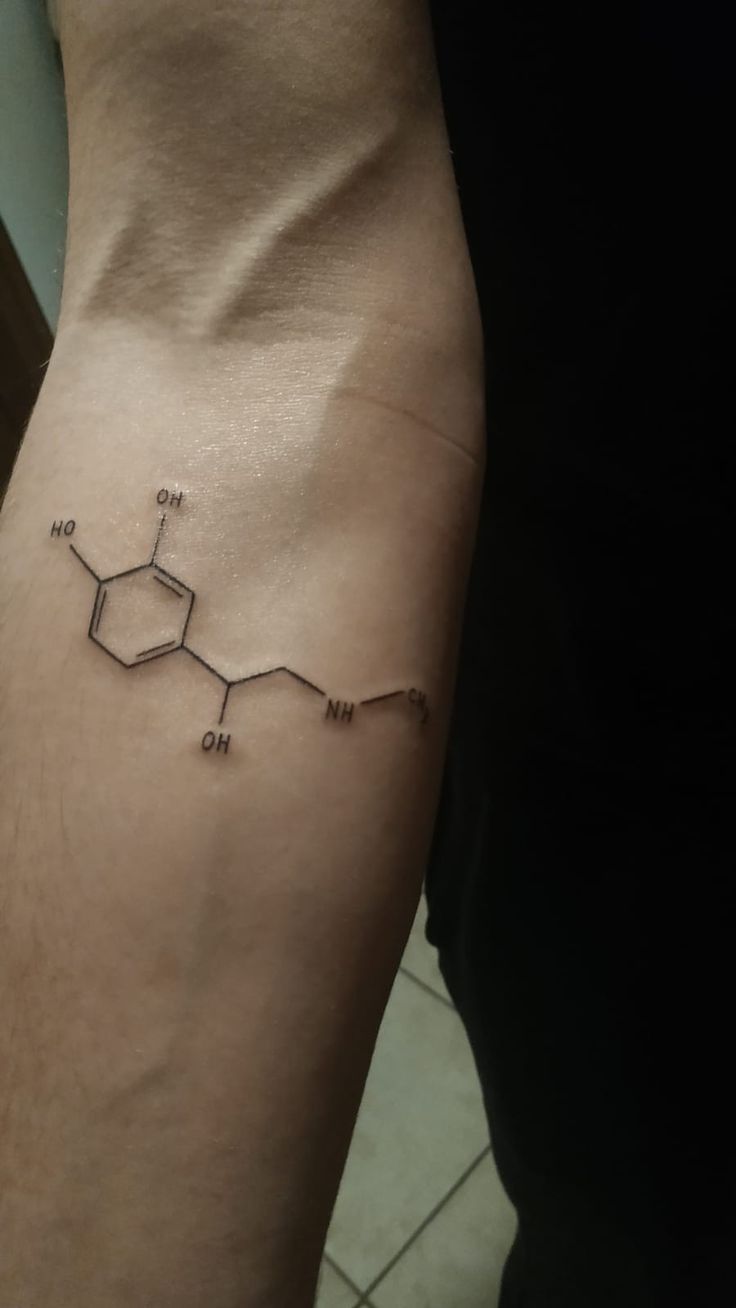 a man's arm with a tattoo on it that has the chemical symbol for one