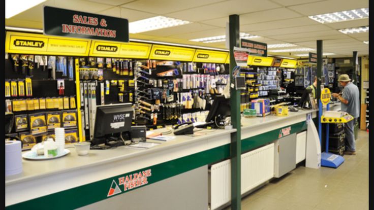 a store filled with lots of items and people standing in front of the cash register