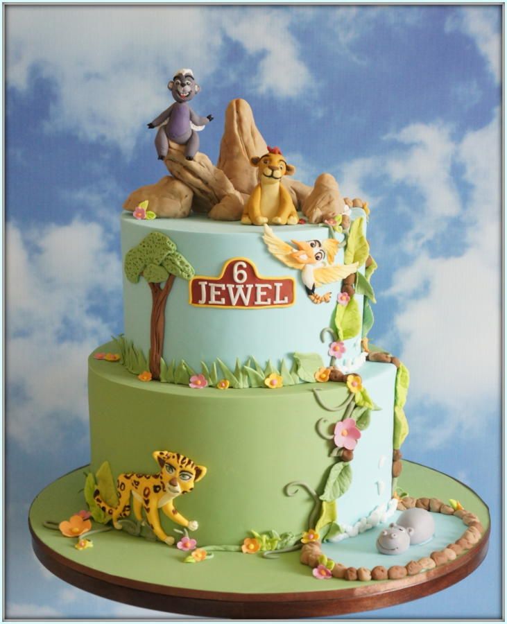 the cake is decorated with different animals and symbols on it's tiered layers