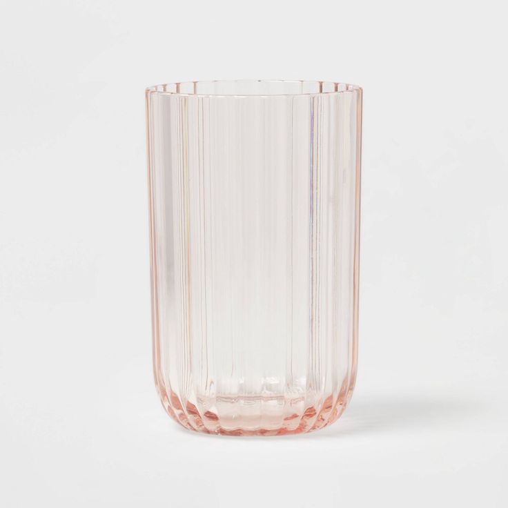 a pink glass vase sitting on top of a white table