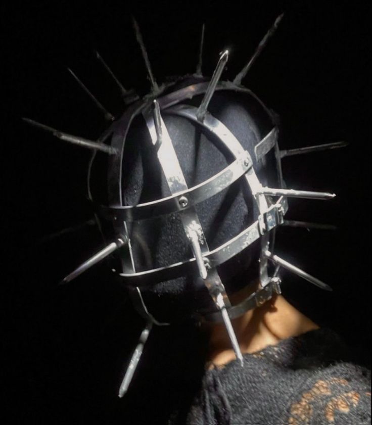 a person with spikes on their head in the dark