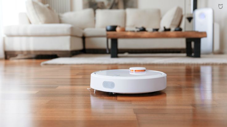 a robot vacuum sitting on top of a hard wood floor