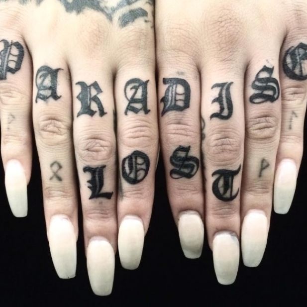 two fingers with tattoos on them are shown