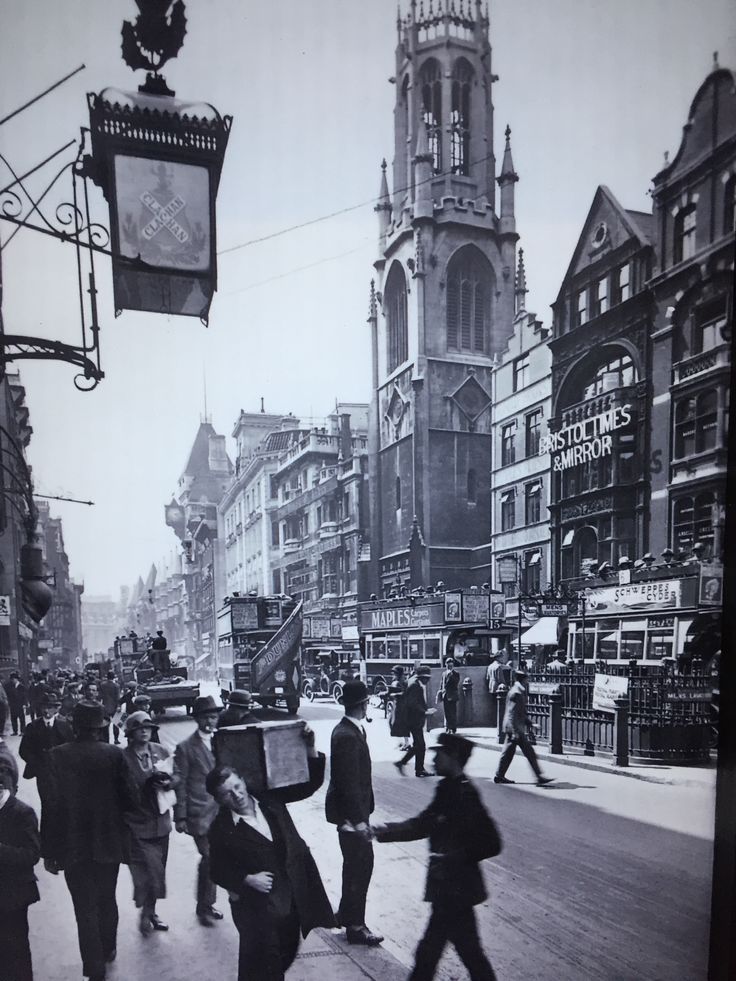 an old black and white photo of people crossing the street