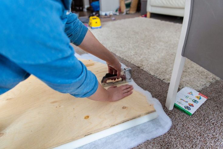 a person is sanding up some wood on the floor