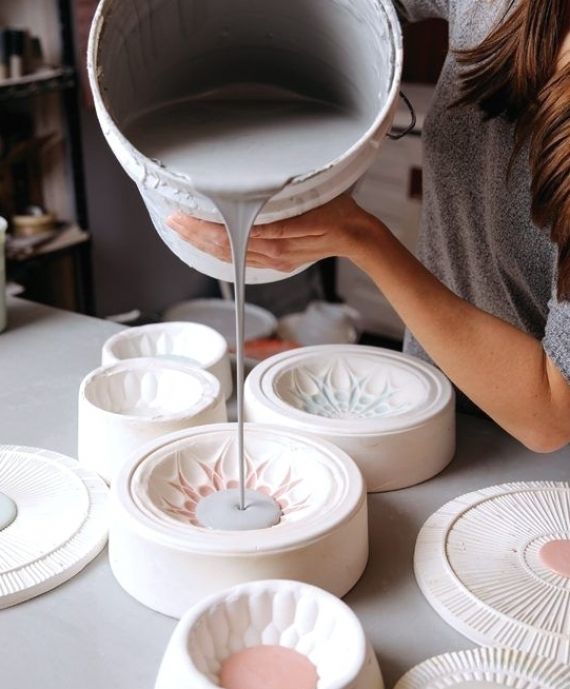 a woman is pouring water into some bowls