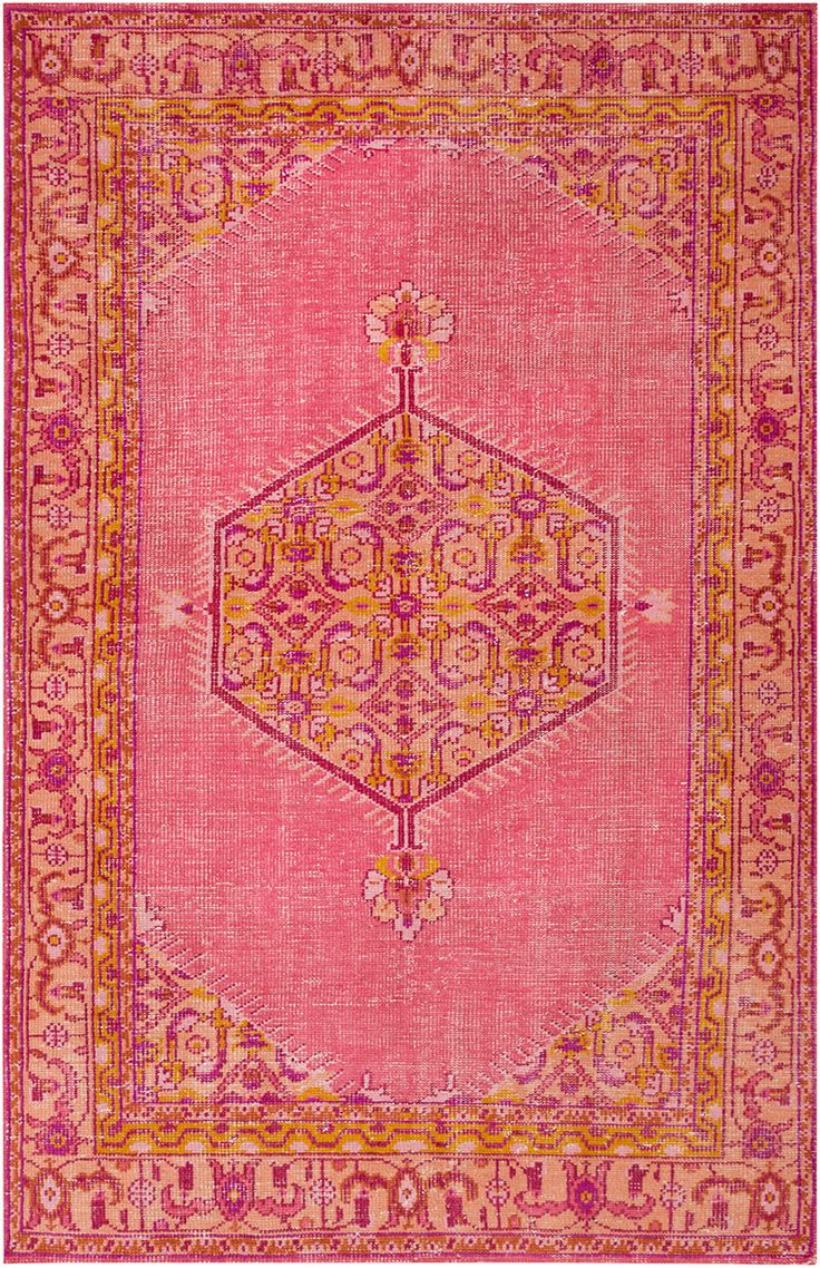 a pink and yellow rug with an ornate design