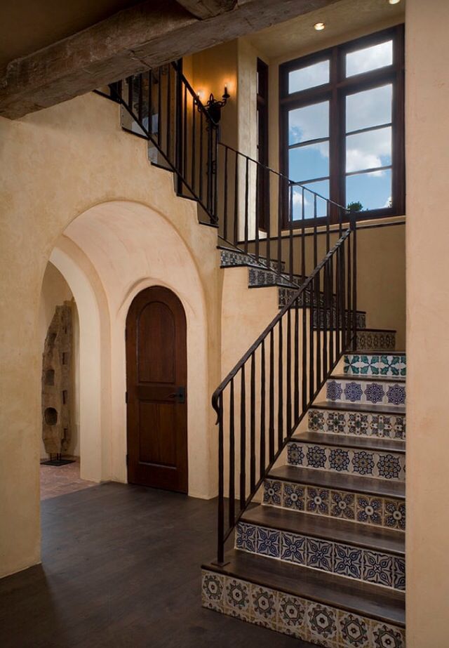 an entry way with stairs and tiled flooring