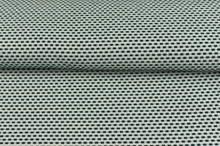 a close up view of a green and white checkerboard pattern on the fabric