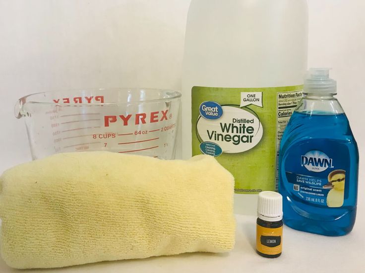 the ingredients to make homemade dish soap are displayed on a white surface, including detergent, cloth, and other items