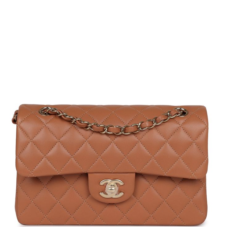 This Chanel Small Classic Double Flap is in Caramel Lambskin with Gold hardware, front flap with CC turnlock closure, half moon back pocket and adjustable interwoven gold chain link and lambskin leather shoulder/crossbody strap. The interior is lined in Caramel leather and features a small zip pocket with Chanel pull and slip pocket underneath on the rear wall.Collection: 2022 (RFID chip)Origin: FranceCondition: New and never worn (plastic on hardware) Accompanied by: Chanel Box, Chanel dustbag, Elegant Brown Bag With Cc Turnlock Closure, Classic Beige Double Flap Bags, Classic Camel Bags With Detachable Strap, Beige Double Flap Leather Bag, Luxury Camel Bag With Detachable Strap, Elegant Brown Flap Bag With Cc Turnlock Closure, Luxury Caramel Top Handle Bag, Classic Cognac Flap Bag With Soft Leather, Classic Brown Bag With Dust Bag