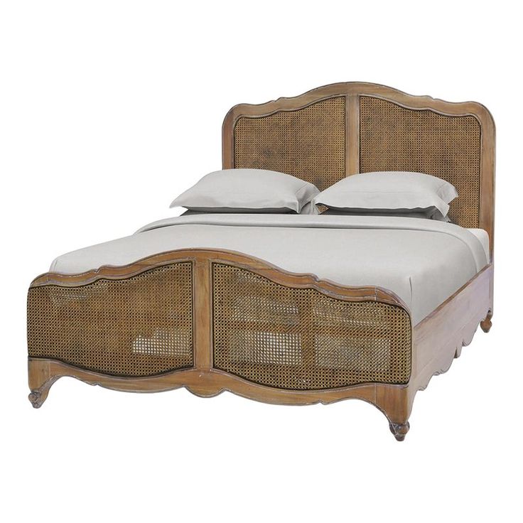 a bed with wicker headboard and foot board, made in the style of an old