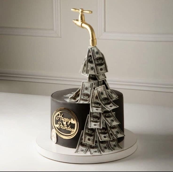 a cake decorated with money and a golden faucet sticking out of the top