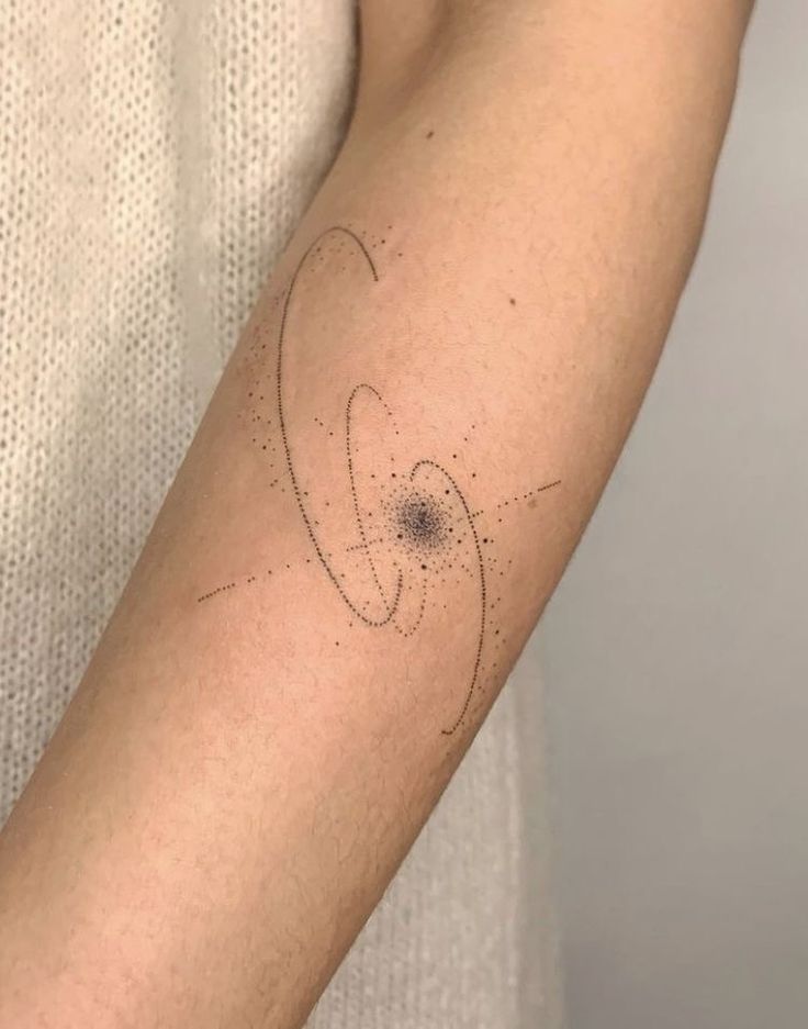 a person with a tattoo on their arm that has circles and dots all over it