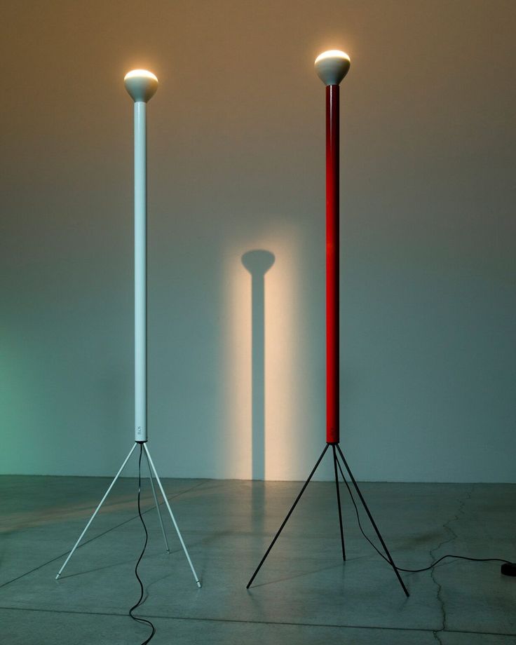 three different colored lamps are on the floor in front of each other, with one light turned on