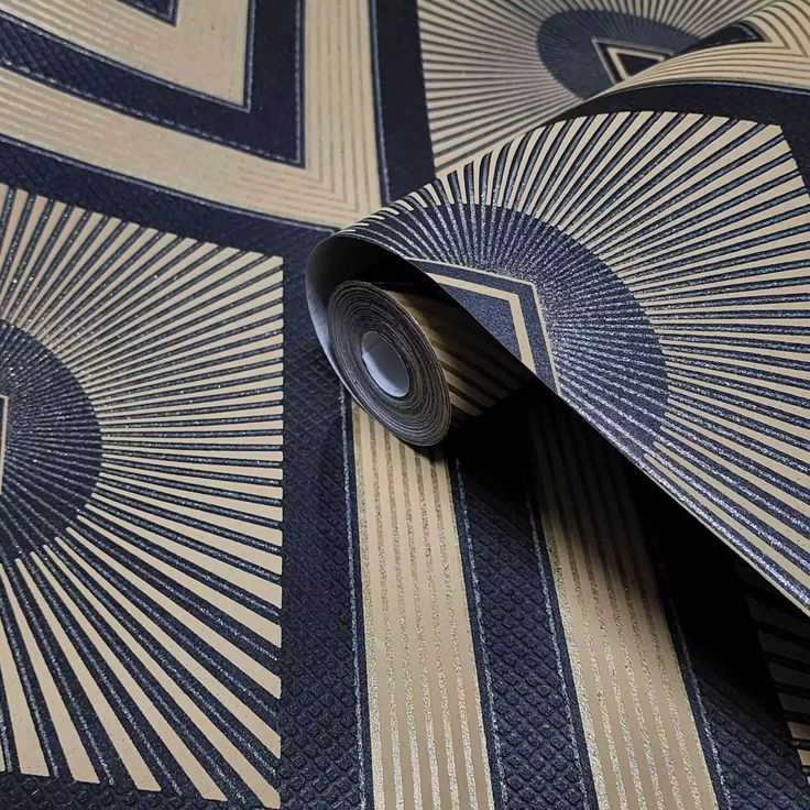 a close up view of a tie on a wallpapered surface with an intricate design