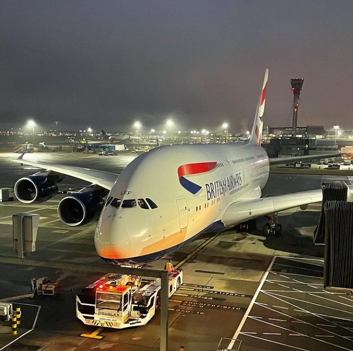 an airplane is parked on the runway at night