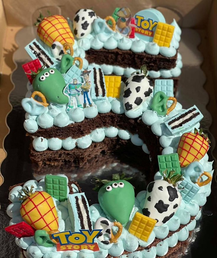 there is a cake that looks like the letter s for toy story on it's side