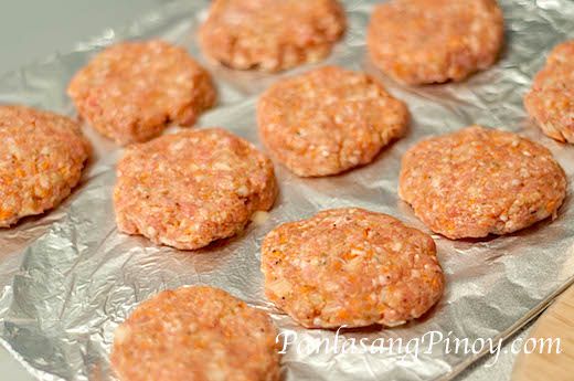 raw hamburger patties on a baking sheet ready to be baked