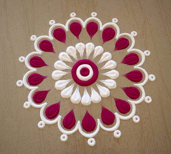 a red and white circular design made out of paper on top of a wooden table