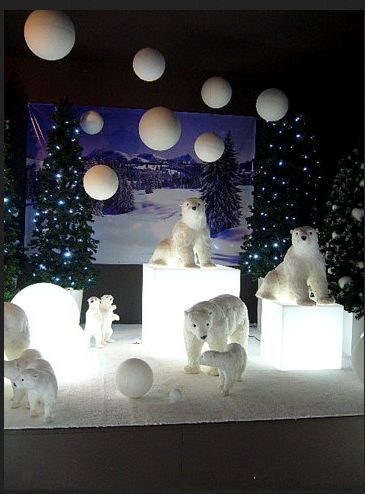 polar bears on ice cubes in front of christmas trees with lights and balls hanging from the ceiling