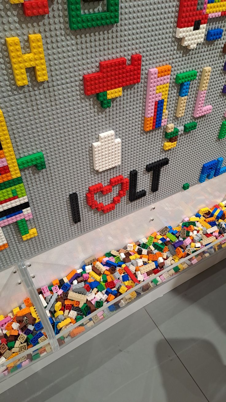 there is a lego wall with letters and numbers on it