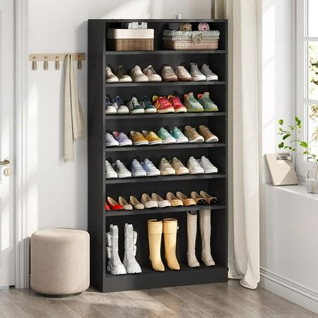 a black shoe rack filled with lots of shoes