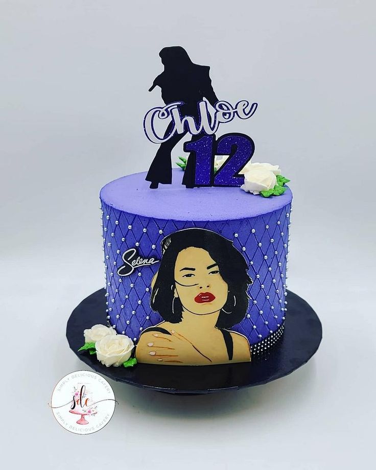 a purple and blue cake with a woman's face on top that has the number 12 on it